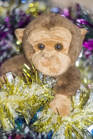 Brown monkey toy with decorated Christmas tree.の写真素材