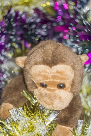Brown monkey toy with decorated Christmas tree.の写真素材