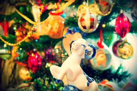 White ceramic ram on background with Christmas decorations, retro photo effect.の写真素材