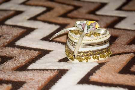 Decorative jewelry box in a shape of a heart on wool blanket.の写真素材