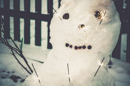 Happy Christmas snowman with bengal fire, vintage background.の写真素材