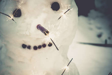 Happy Christmas snowman with bengal fire, vintage background.の写真素材