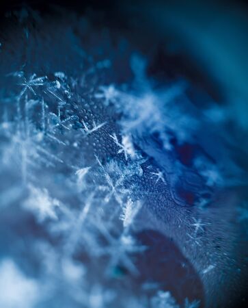 Extremely close up image of snowflakes, vintage photo effect.の写真素材