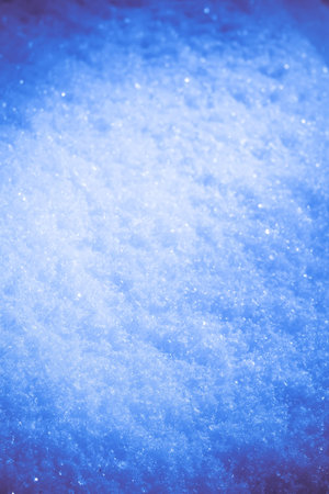 Close up image of snow texture, toned natural background.