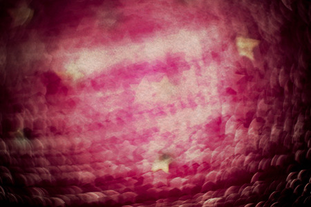 Textile of pink color decorated with strasses, bokeh effect, textured with paper.の写真素材