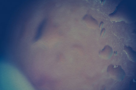 Water drops on window, shallow focus, vintage photo effect with paper texture.