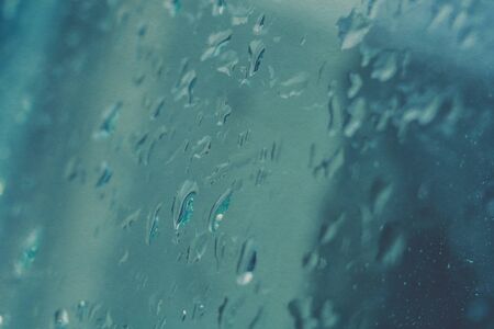 Water drops on window, shallow focus, vintage photo effect with paper texture.の写真素材