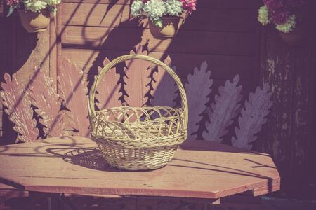 Background with an empty wicker woven basket, vintage photo effect.の写真素材