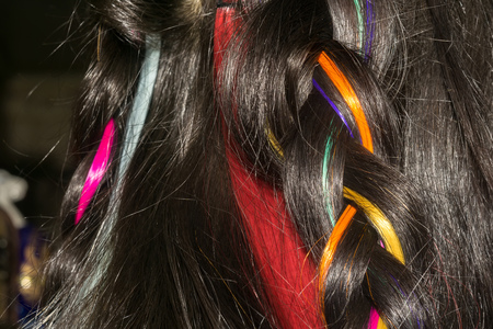 Dark brown hair with colorful synthetic clip in extensions macro.の写真素材