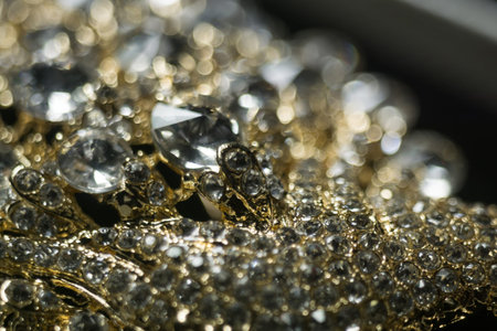 Diamonds in different sizes, golden jewelry close up background.の写真素材