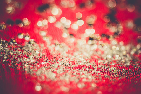 Big silver glitters on pink background, macro with shallow focus, bokeh with vintage effect.の写真素材