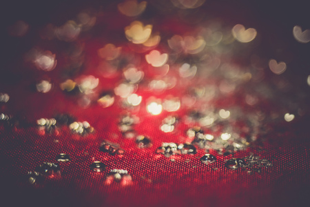 Big silver glitters on pink background, macro with shallow focus, bokeh with vintage effect.の写真素材