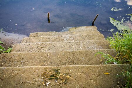 Old concrete stairs and forest river background.の写真素材