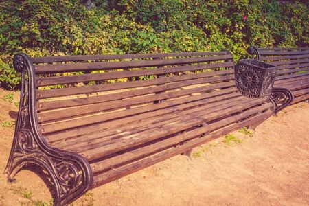 Vintage lonely wooden bench in the city park.の写真素材