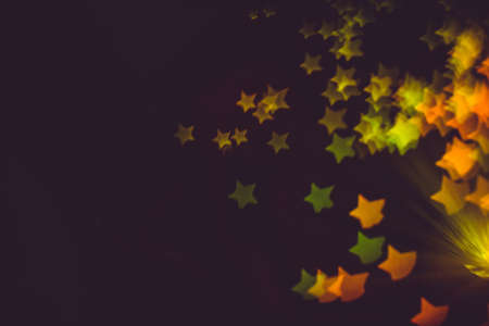 Defocused background with colorful bokeh in a shape of a star.の写真素材