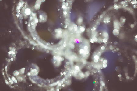 Defocused Ornamental silver snowflake glittering on fresh white snow, filtered retro colors.の写真素材