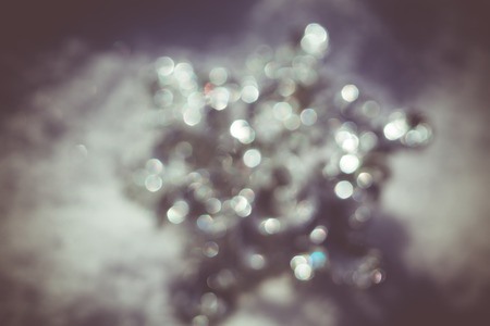 Defocused Ornamental silver snowflake glittering on fresh white snow, filtered retro colors.の写真素材