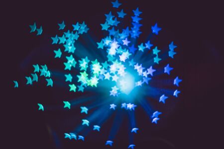Defocused background with colorful bokeh in a shape of a star.の写真素材