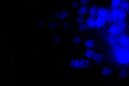 Defocused background with colorful bokeh in a shape of a star.の写真素材