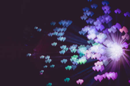 Defocused background with colorful bokeh in a shape of a heart.の写真素材