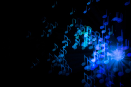 Defocused background with colorful bokeh in a shape of a music notes.の写真素材