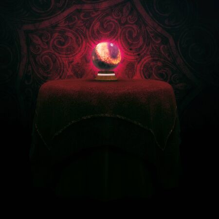 Fantasy magic crystal ball on the table with red clothの写真素材