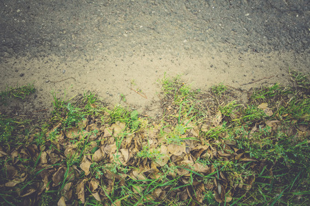 Old cracked, damaged asphalt road in countryside, vintage colors.の写真素材