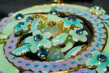 Blue pendant in a shape of a flower close up.