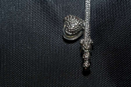 Silver pendant heart shaped key, made with pink crystal stones macro.の写真素材