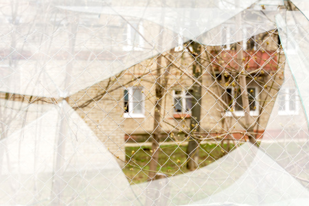 Sharp glass hole cracks splinters, broken glass by the street.の写真素材