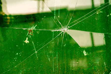 Sharp glass hole cracks splinters, broken glass by the street.の写真素材