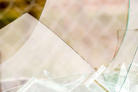 Sharp glass hole cracks splinters, broken glass by the street.の写真素材