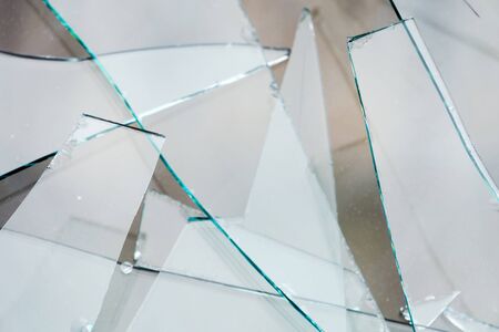 Sharp glass hole cracks splinters, broken glass by the street.の写真素材