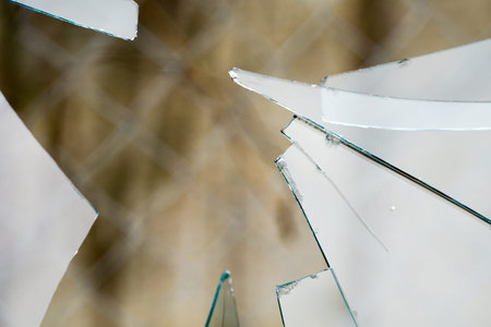 Sharp glass hole cracks splinters, broken glass by the street.の写真素材