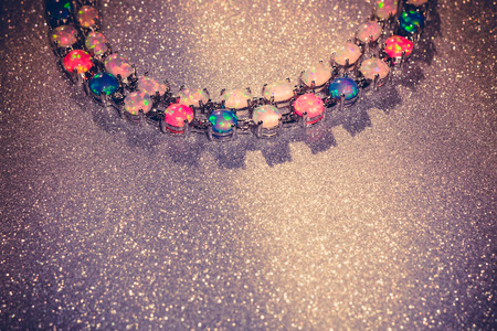 Fashion bracelet with multicolored fire opal stones on glittering background.の写真素材