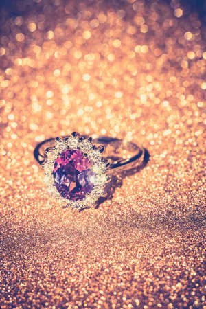 Fashion silver ring with purple amethyst on glittering background.の写真素材
