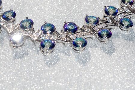 Fashion bracelet with mystic topaz, rainbow topaz on glittering background.の写真素材