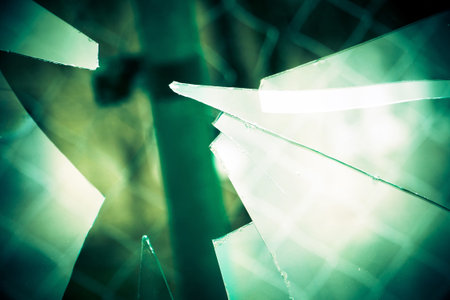 Sharp glass hole cracks splinters, broken glass by the street, retro colors.の写真素材