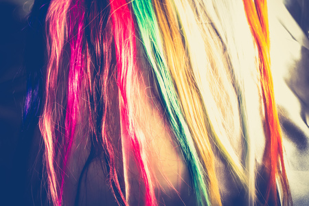 Synthetic hair extensions of different colors close up background.の写真素材