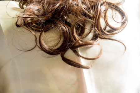 Brown synthetic curly hair close up background.