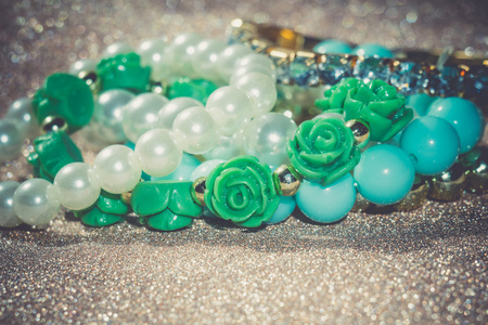 Stylish fashion bracelets with blue beads and pearls on glittering background.の写真素材