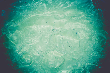 Surface of splashing water textured as abstract background.の写真素材