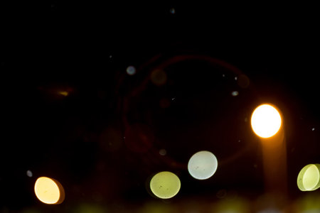 Blurred night lights and snowfall, bokeh effect background.