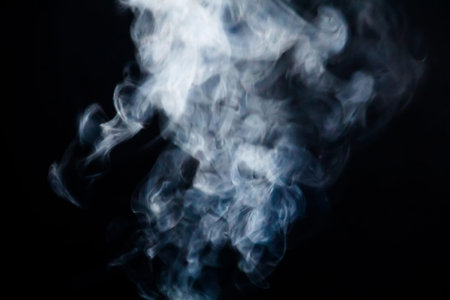 Abstract white smoke texture on a dark background.