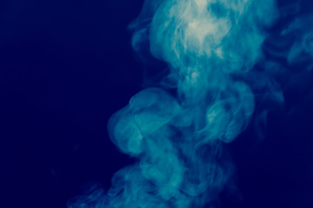 Abstract white smoke texture on a dark background, post processing.の写真素材