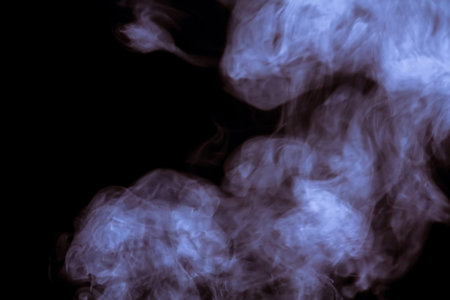 Abstract white smoke texture on a dark background, post processing.
