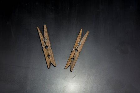 Two small old wooden clothes pins close up.の写真素材