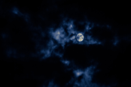 Photo of night cloudy sky and moon, defocused background. Not an illustration.の写真素材
