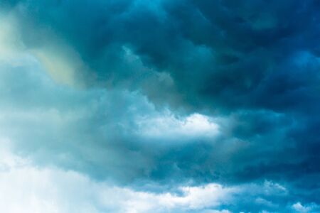 Dramatic stormy black sky clouds before rain, filtered background.の写真素材