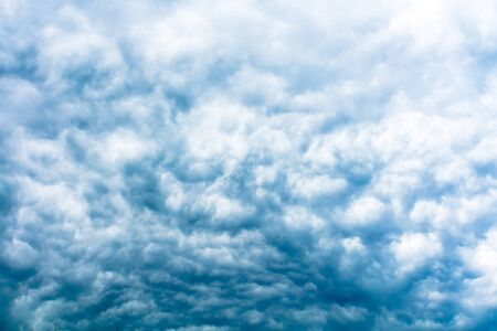 Dramatic stormy black sky clouds before rain, filtered background.の写真素材
